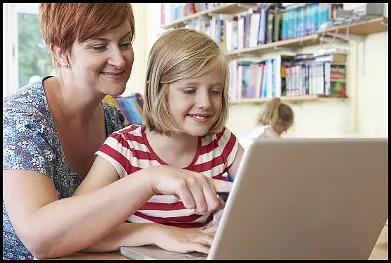 Woman and Child Looking at Laptop